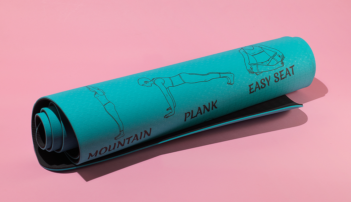 item 8 of Gallery image - a rolled up yoga mat that has diagrams of several yoga poses along with their names