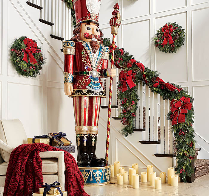 item 6 of Gallery image - Christmas decor display of a Nutcracker statue on display in a home decorated with wreaths, candles