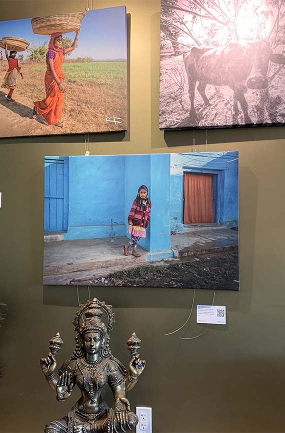 wall of photos and statue inside of the Narmada Winery