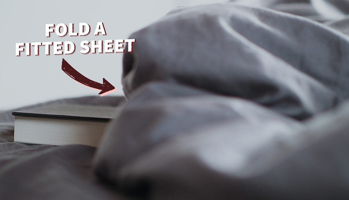 a wrinkled bed sheet with the caption how to fold a fitted sheet