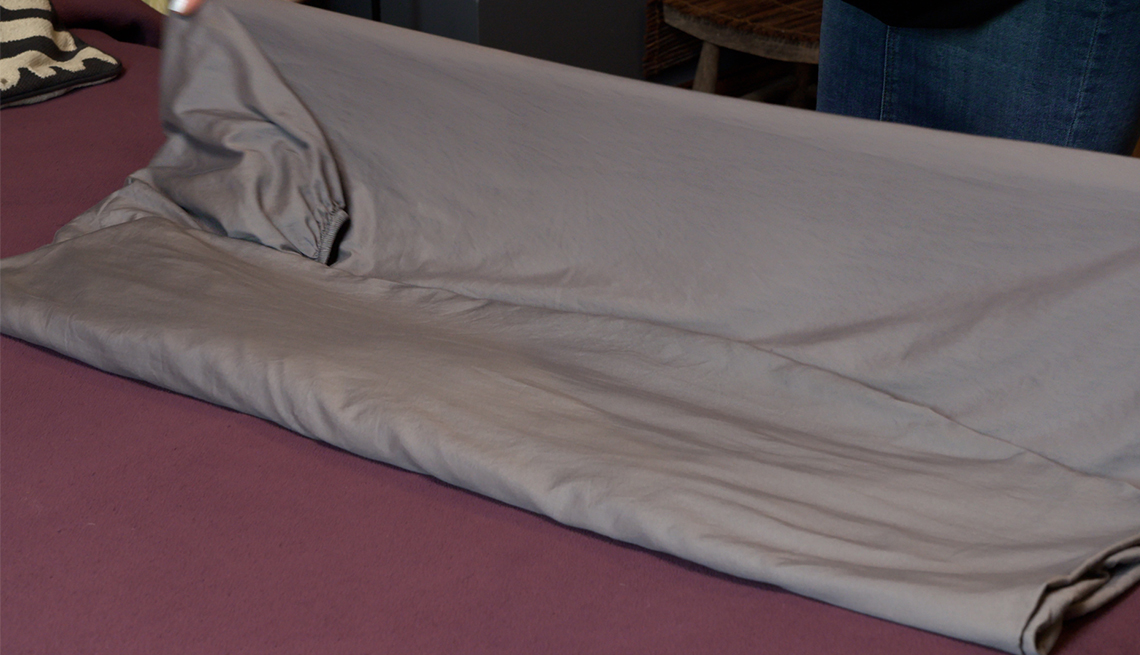 item 5 of Gallery image - fitted sheet on bed being folded