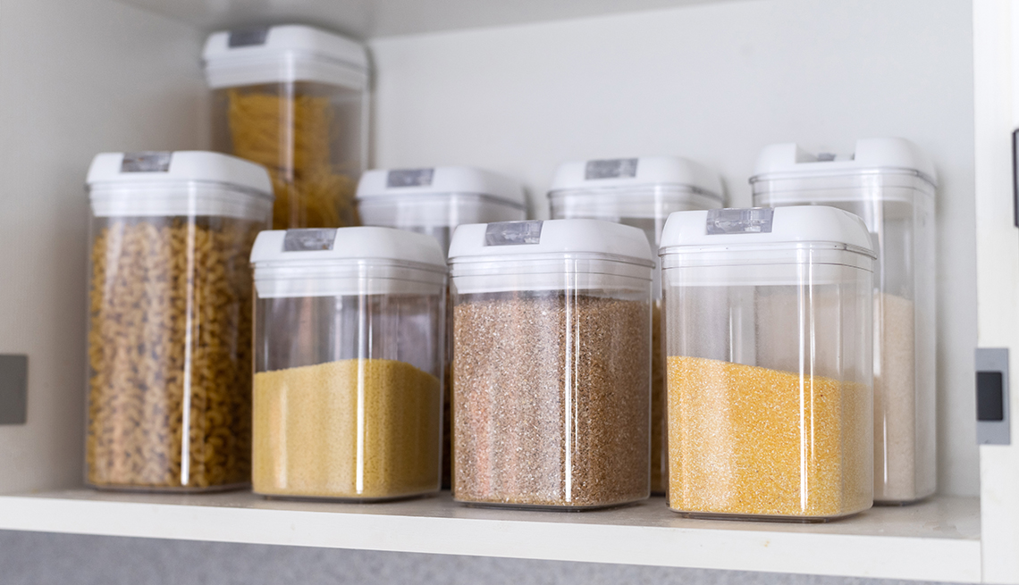 clear food storage containers arranged neatly in a cabinet