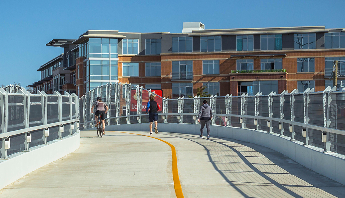 item 5 of Gallery image - people using a pedestrian overpass bridge for bicycling running and walking in a densely populated suburban area