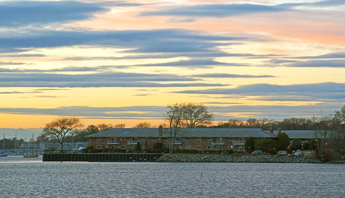 item 10 of Gallery image - sunset scene over an apartment building on a spit of land in a bay in manorhaven long island new york