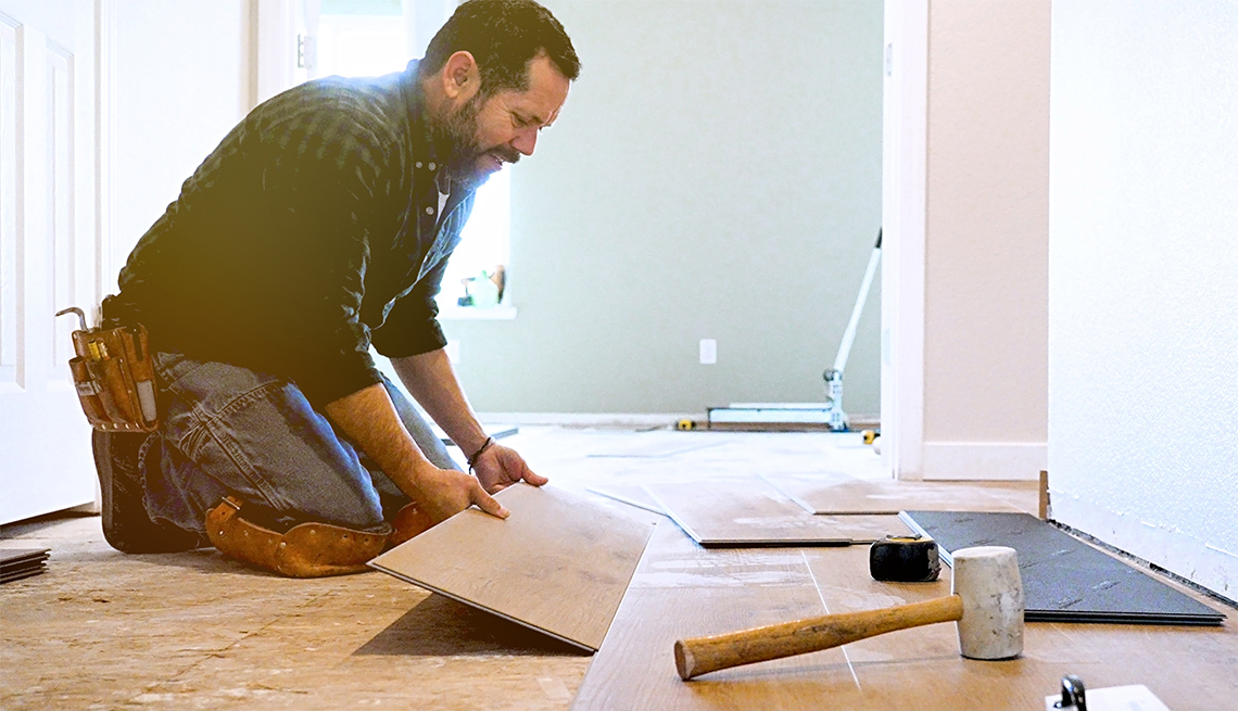 man installing wooden vinyl floor