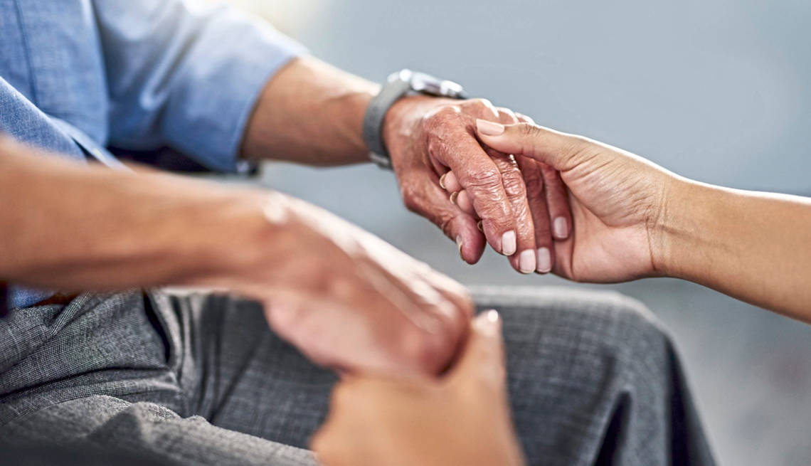 hands shot of a caregiver holding hands with an older adult