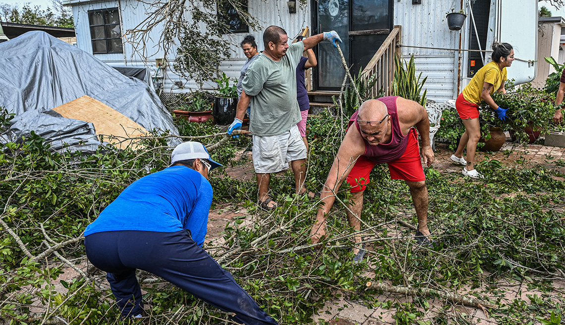 Residents of mobile homes clean up debris in the aftermath of Hurricane Ian, in Fort Myers, Florida