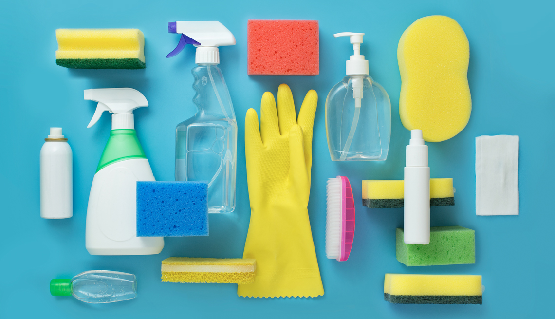 assorted cleaning supplies such as sponges gloves and spray bottles