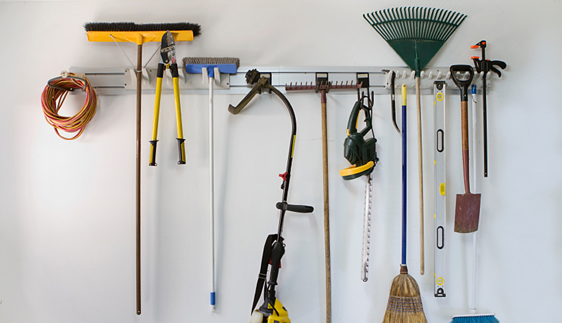 Tools Handing From Bar In Garage, AARP Home And Garden, Home Improvement, How To Organize A Garage
