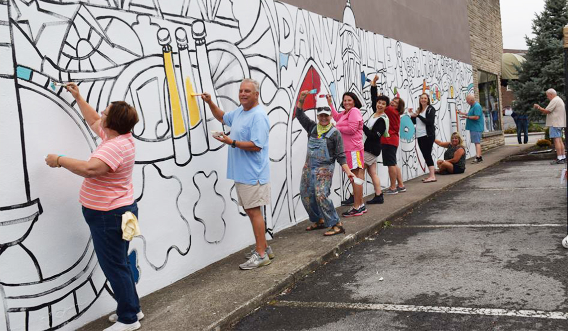 Community members paint a mural in Danville, Kentucky