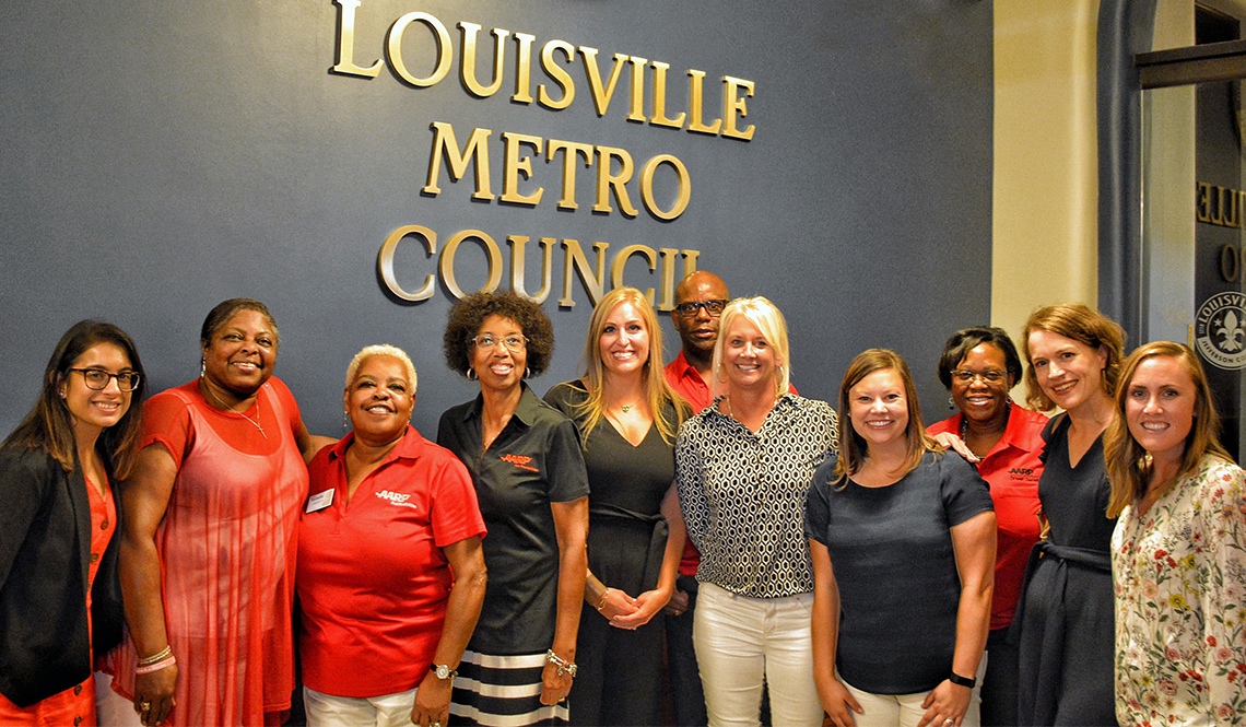 Community representatives and volunteers with Age-Friendly Louisville post for a photo at the offices of the Louisville Metro Council