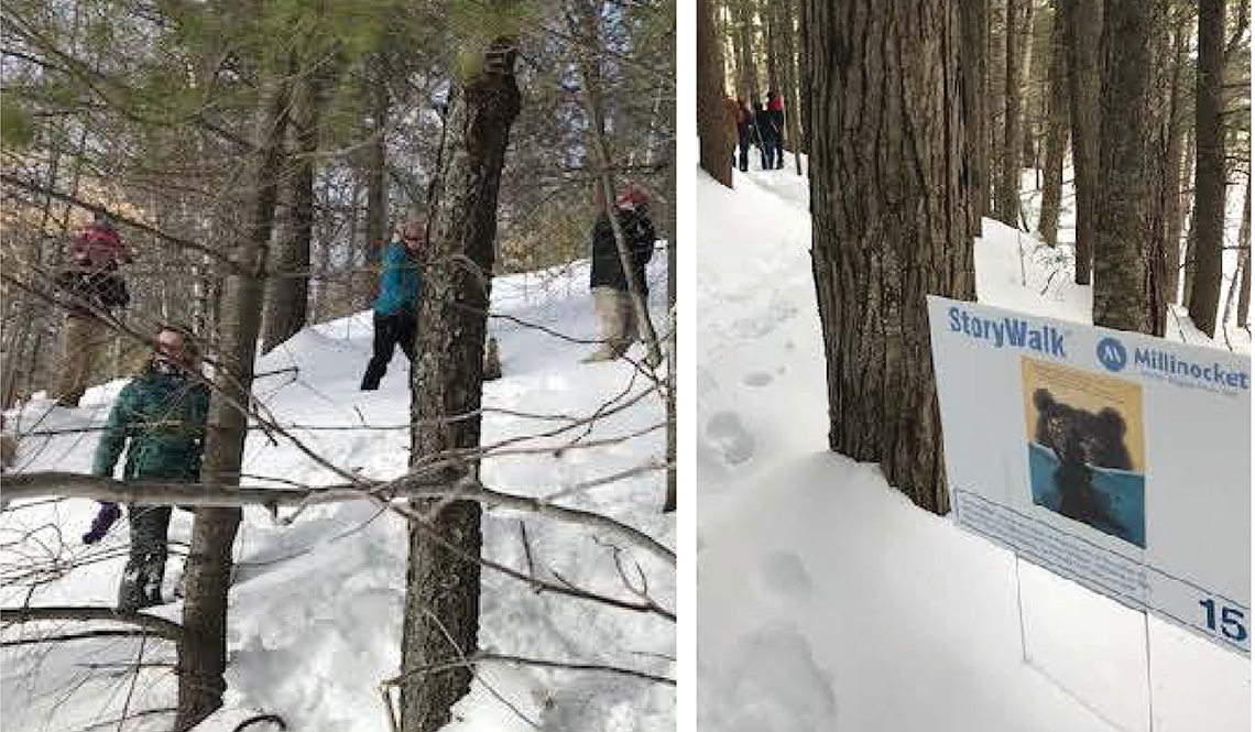 People hike in the snow while following a StoryWalk path