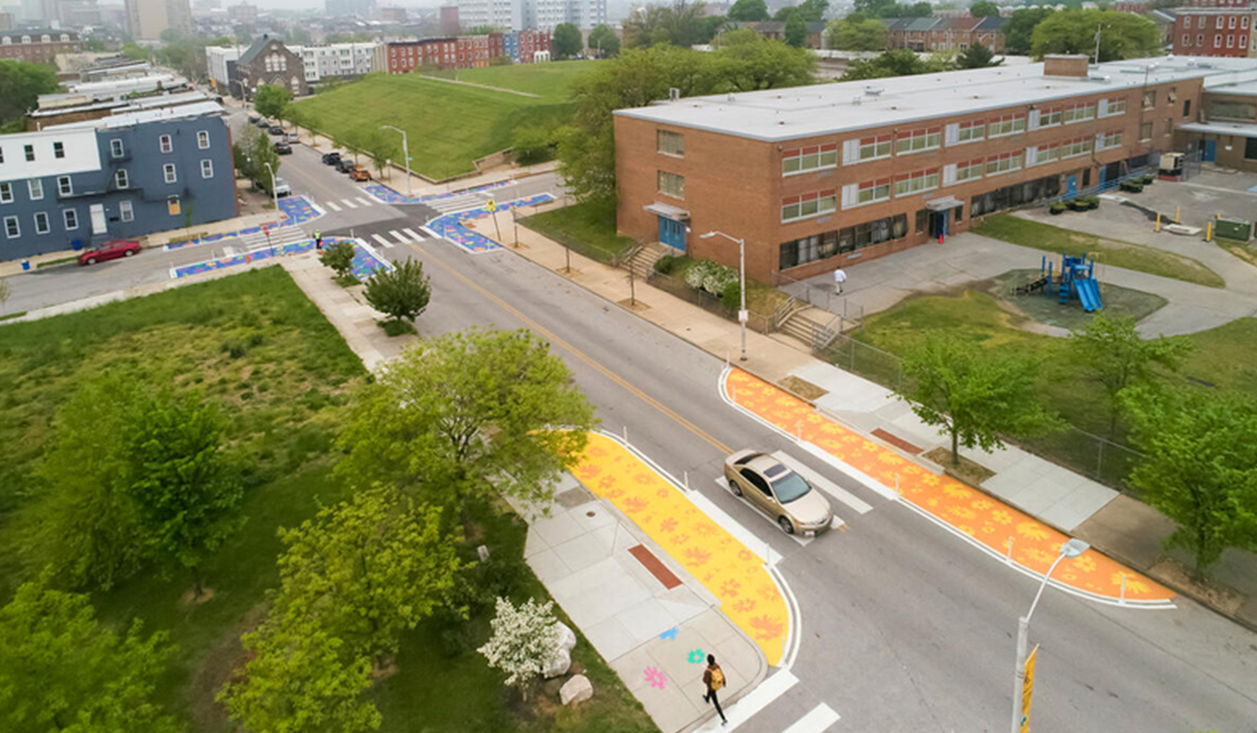 Painted bulb-outs narrow a roadway (and driving speeds) near a school