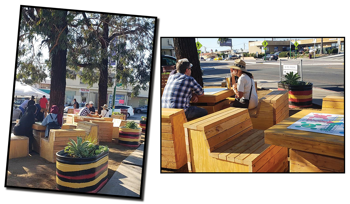 People enjoying the wooden tables, benches and colorful planters in a public plaza