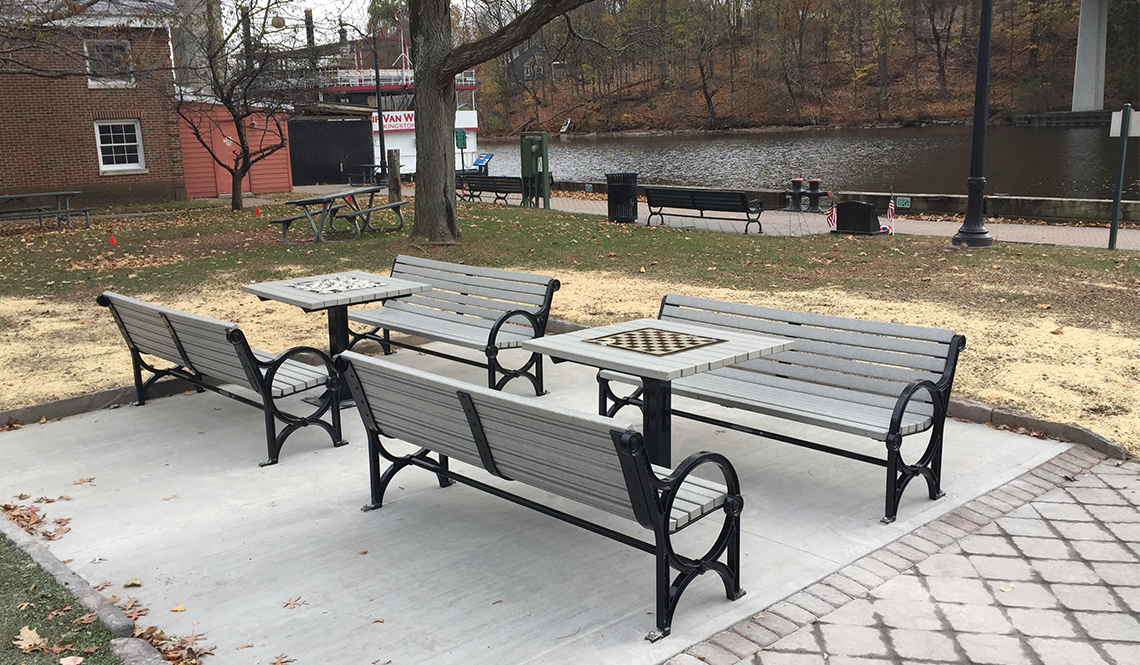 Four benches and two chess-checkers tables in Kingston, New York, created with funding from the AARP Community Challenge