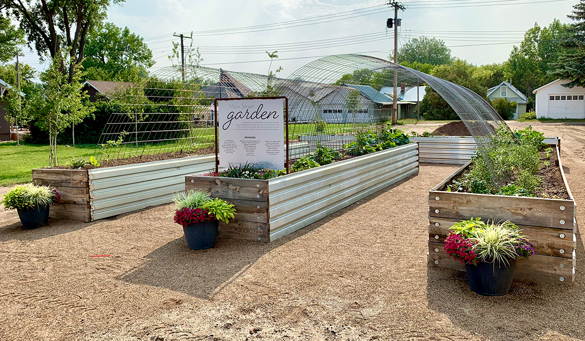 Four long planters and a sign that says Main Street Garden