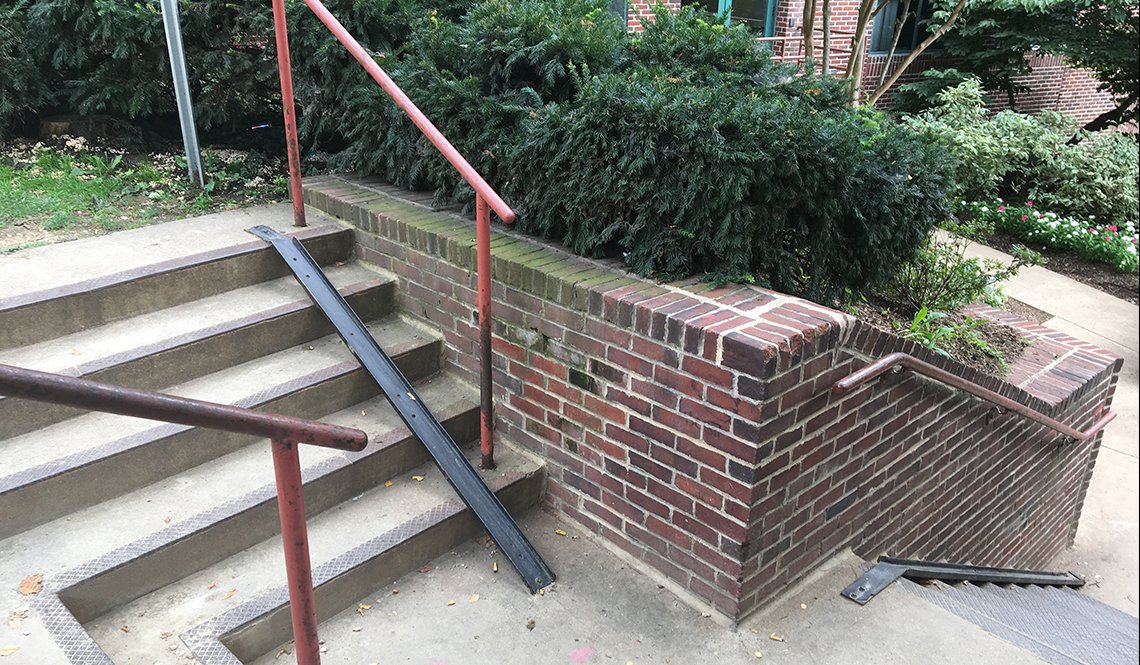 A narrow, metal bicycle ramp in Washington DC enables cyclists to roll rather than carry their bicycle down a flight of stairs