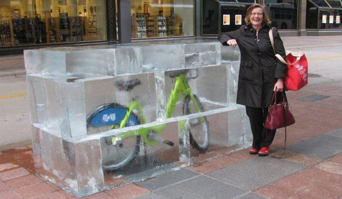 Minneapolis resident Phyllis Rodan poses next to a Nice Ride bike-share bicycle encased in fake ice