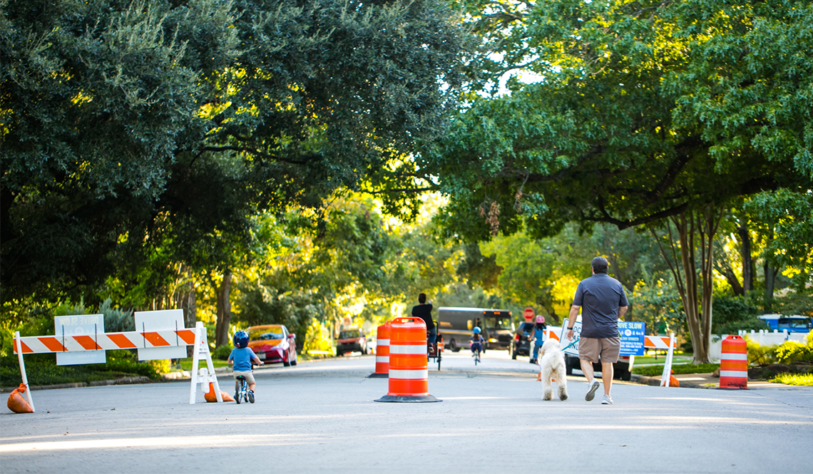 Pedestrians and children on bicycles take advantage of one of Austin's Healthy Streets. 