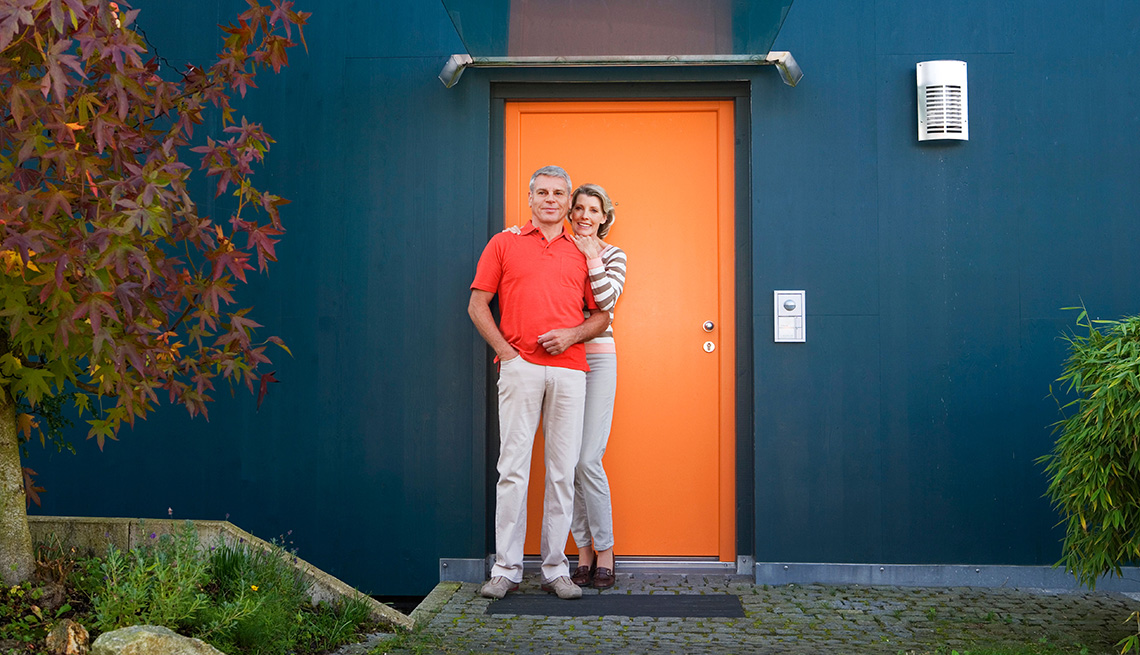 Mature Couple Stands Outside Of Their Home, Livable Communities, 8 Features Of An Age Friendly Community