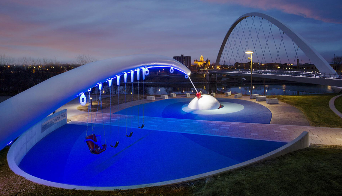 A nighttime photo of the fishing-rod themed Rotary Riverwalk Park in Des Moines, Iowa