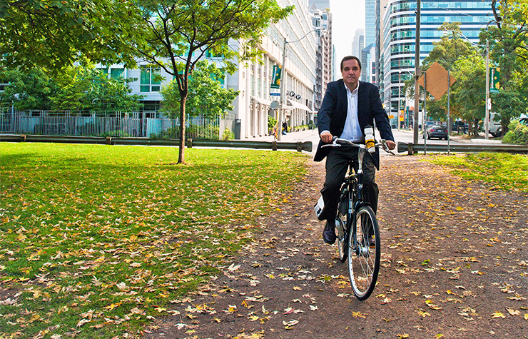 Livability advocate Gil Penalosa rides a bicycle in Toronto