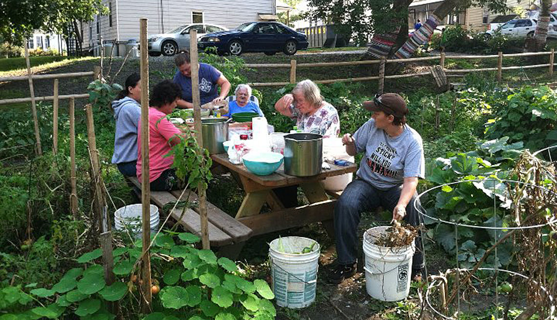 Neighbors Harvesting From Community Garden, How To Create And Maintain A Community Garden, Livable Communities
