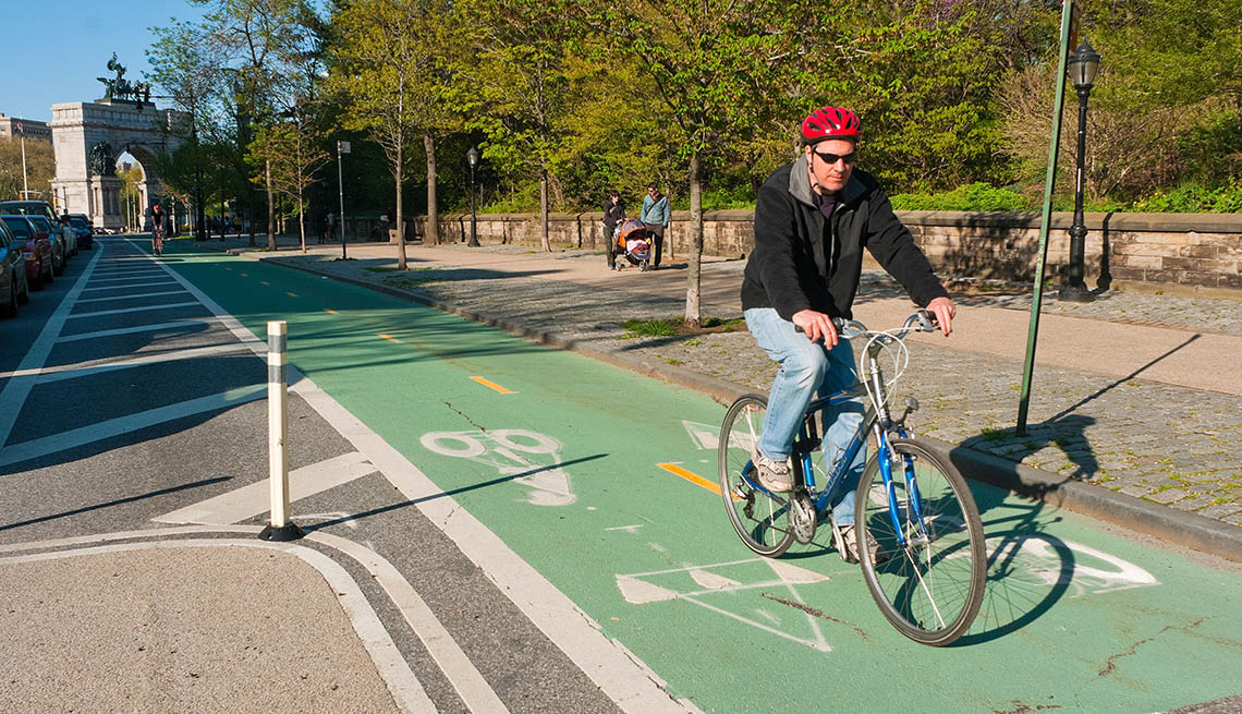 Man Rides His Bike In The Dedicated Bike Lane In Street, City, Urban Setting, Trees, In Livable Communities Slideshow