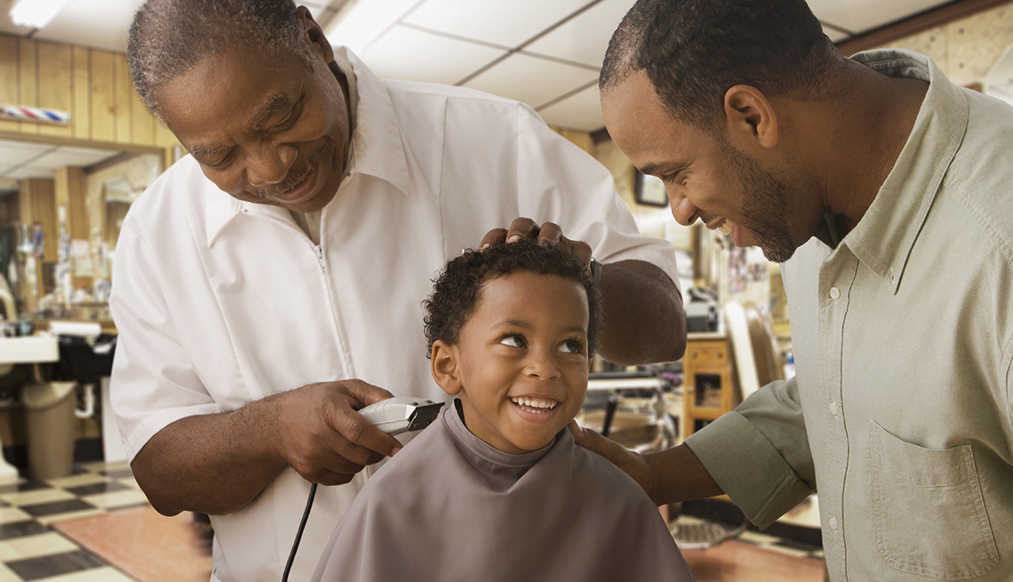 Young Black Boy Smiles At His Dad While He Gets A Haircut At Barbershop, Barber, Dad, In Livable Communities Slideshow