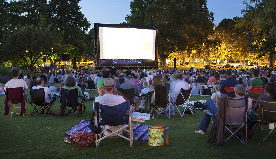 A Crowd Of People Sit On The Grass In Park To Watch A Free Movie, Movies In The Park, In Livable Communities Slideshow