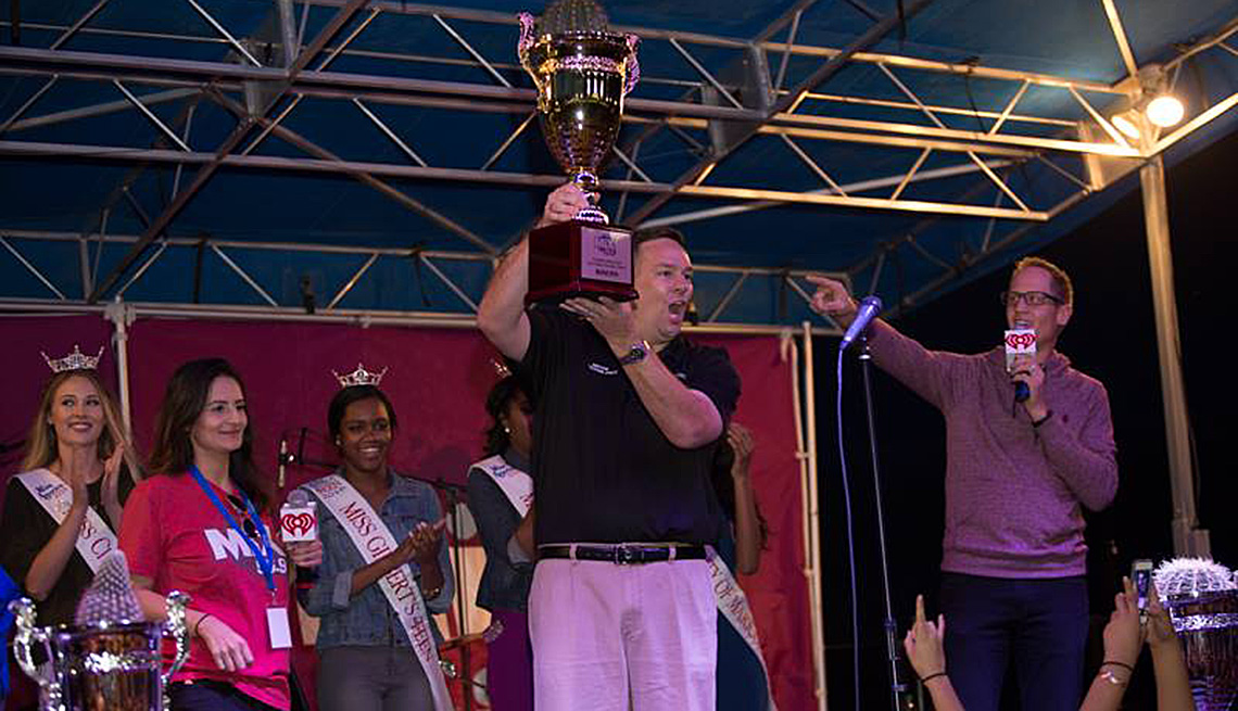 Man Accepts Trophy On Stage, Advocates Program, Livable Communities