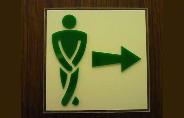 Sign indicating the location of a rest room.