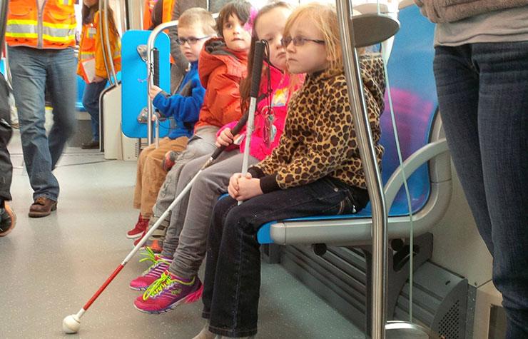 Children with vision impairments take a ride on the Kansas City, Missouri, streetcar.