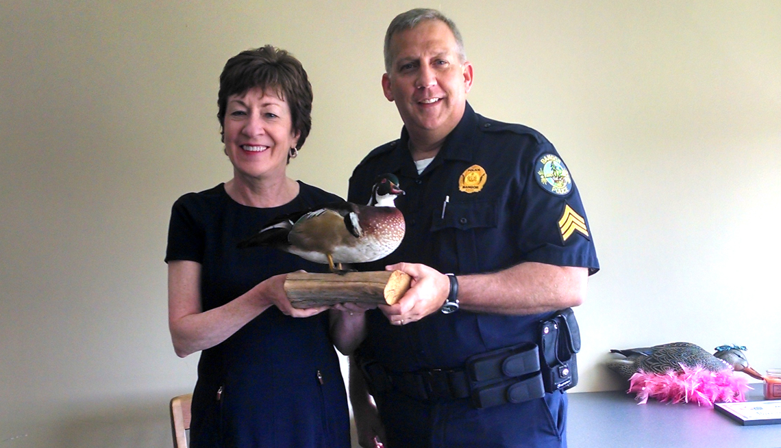 U.S. Sen. Susan Collins of Maine and Bangor Police Department Sgt. Tim Cotton pose with the Duck of Justice