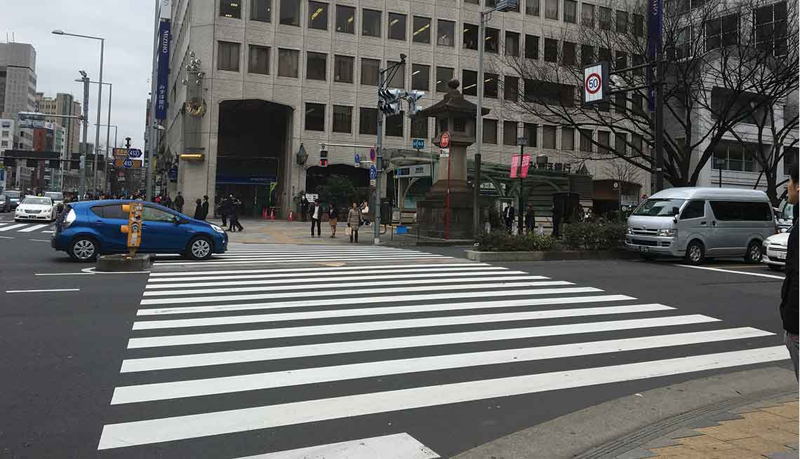 A very wide crosswalk in downtown Tokyo.