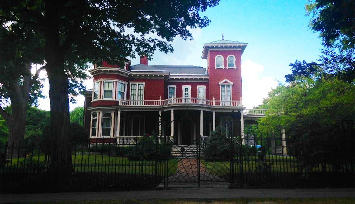 The Bangor, Maine, home of author Stephen King features a red exterior, a turret and an insect-themed iron gate. 