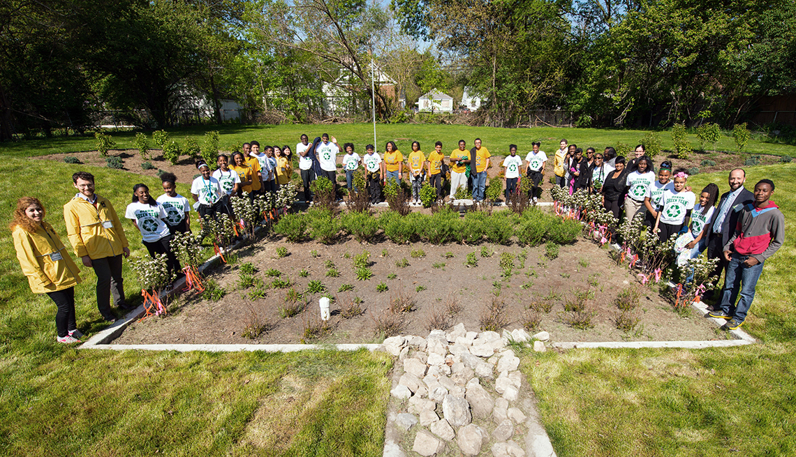 Community leaders, residents and students celebrate the transformation of a vacant lot into a biorention garden in Detroit, Michigan