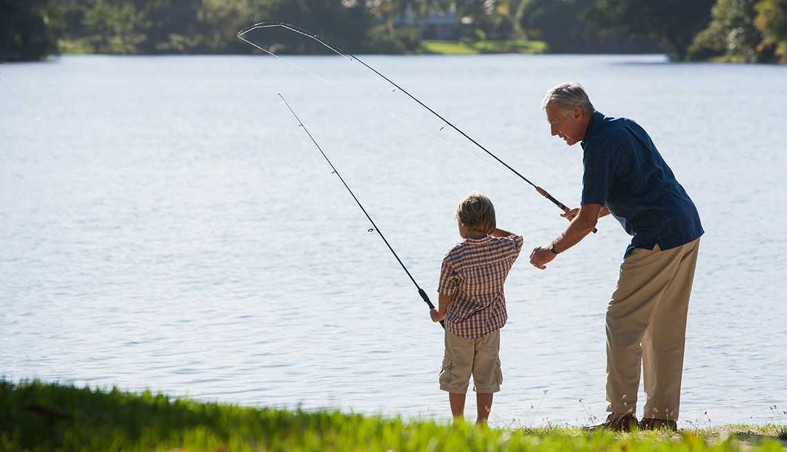 Grandfather and boy fishing together.