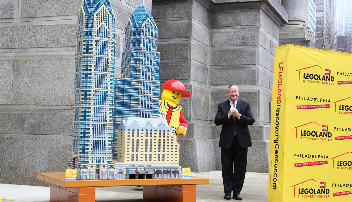 Philadelphia Mayor Jim Kenney and a life-size LEGO character pose together at an event.