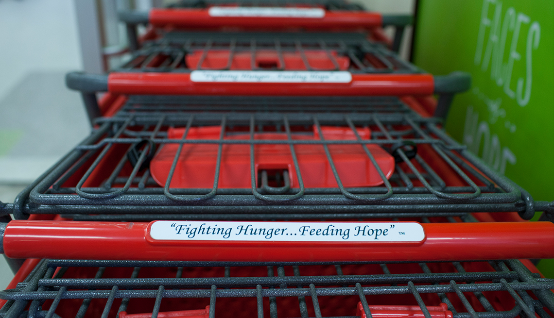 A shopping cart handle with a plaque that states Fighting Hunger ... Feeding Hope
