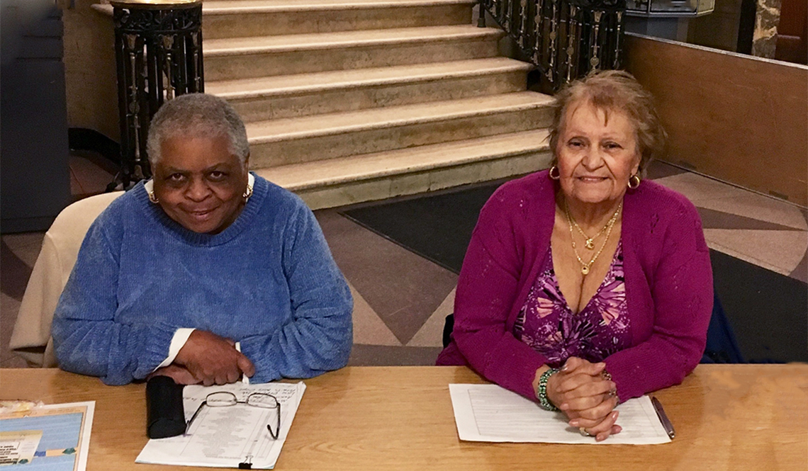 Two women volunteer as City Hall greeters in Medford, Massachusetts