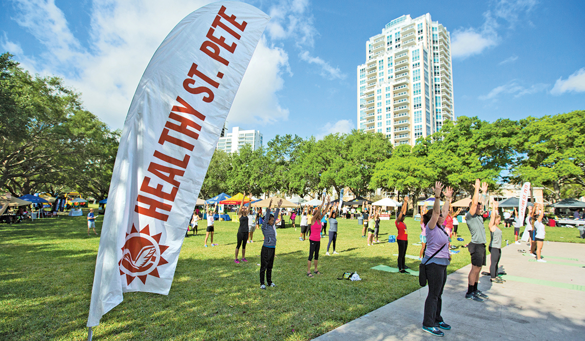 A group exercise class takes place in a St. Petersburg, Florida, park as part of the annual Healthy St. Pete festival