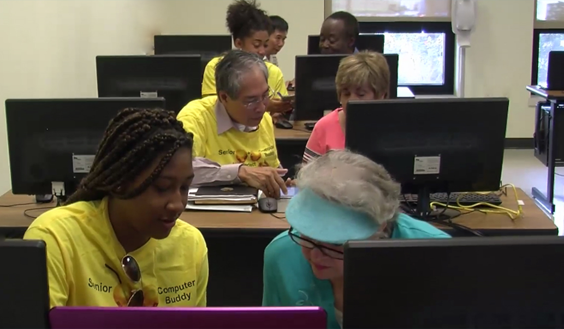 Volunteers teach computer skills to older adults at a senior center