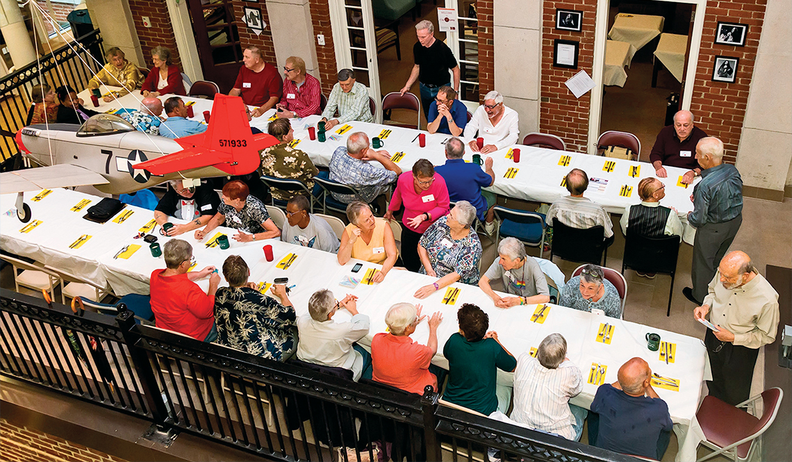 Diners gather at long tables for an Out4Supper dinner.