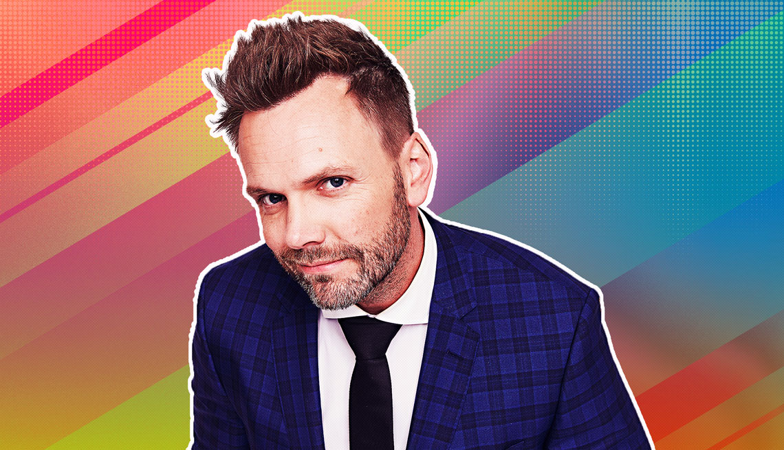 item 11 of Gallery image - Joel McHale in a jacket and tie outlined against a rainbow ombre background