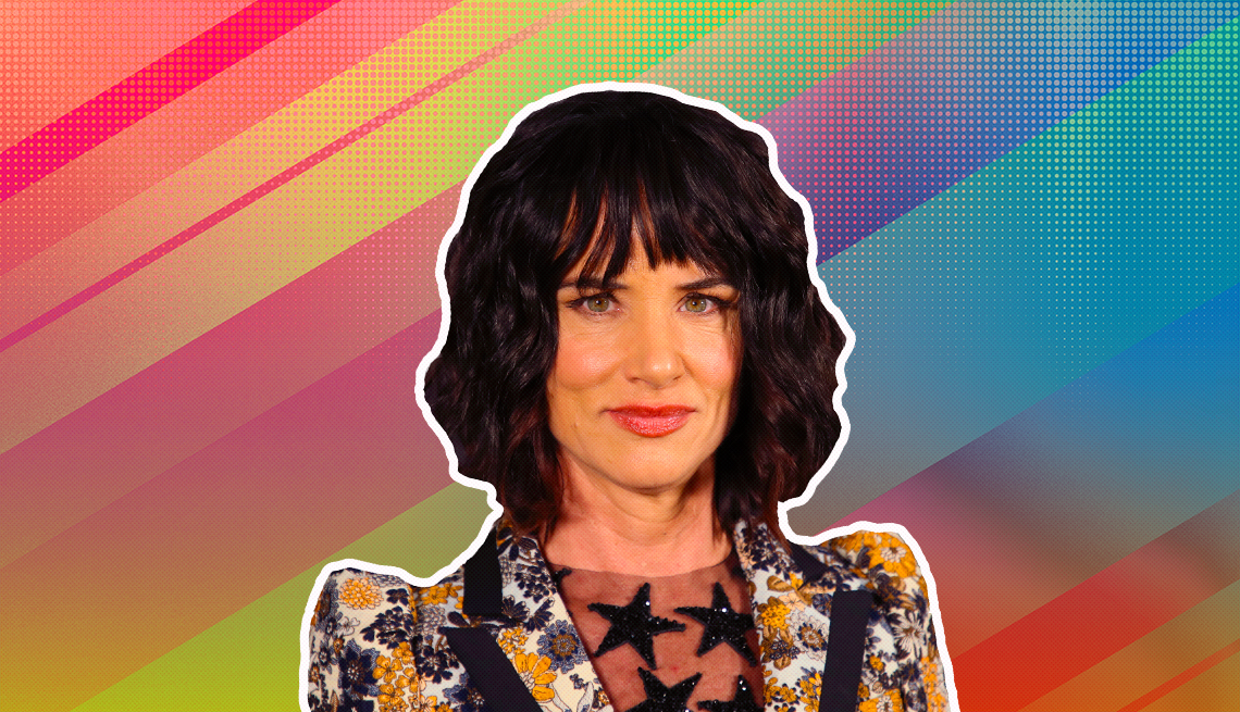 Juliette Lewis outlined against a rainbow ombre background