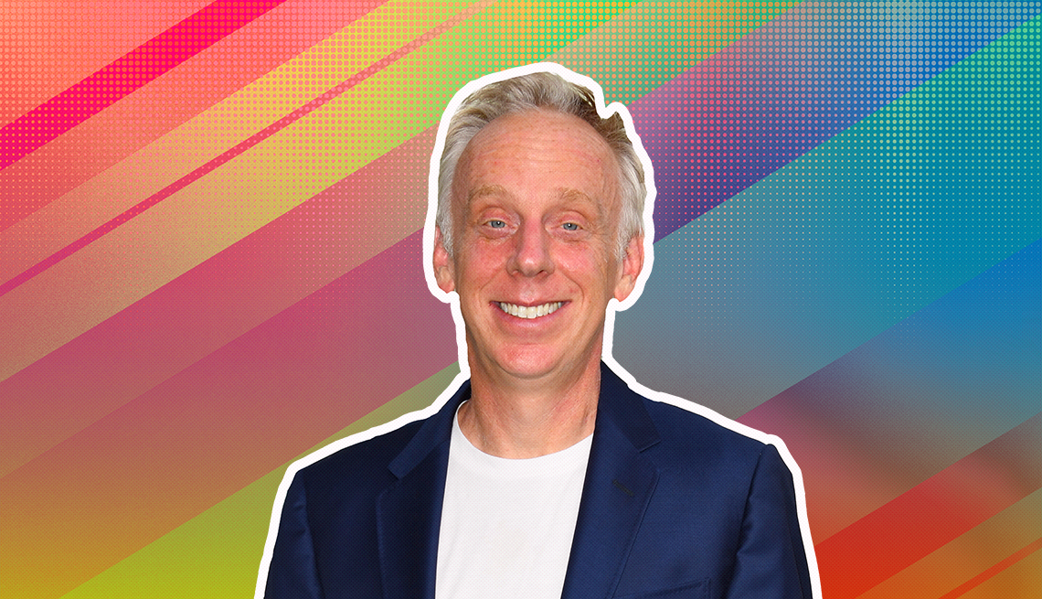 Mike White outlined against a rainbow ombre background