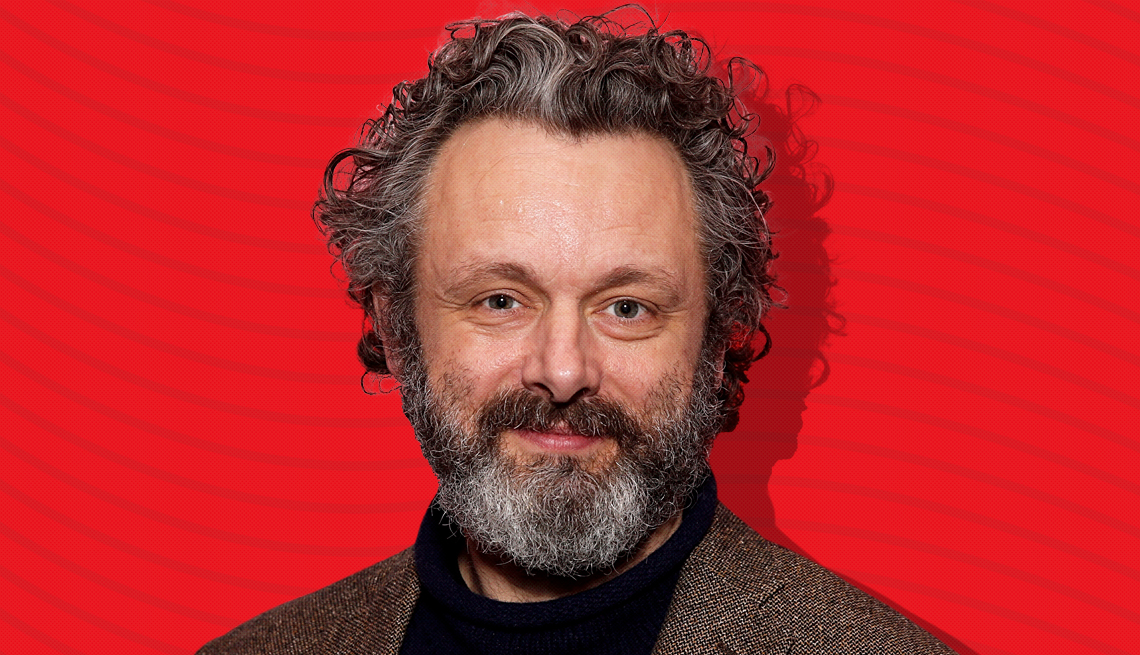 item 24 of Gallery image - michael sheen against red background with curved lines going horizontally from one end to the other