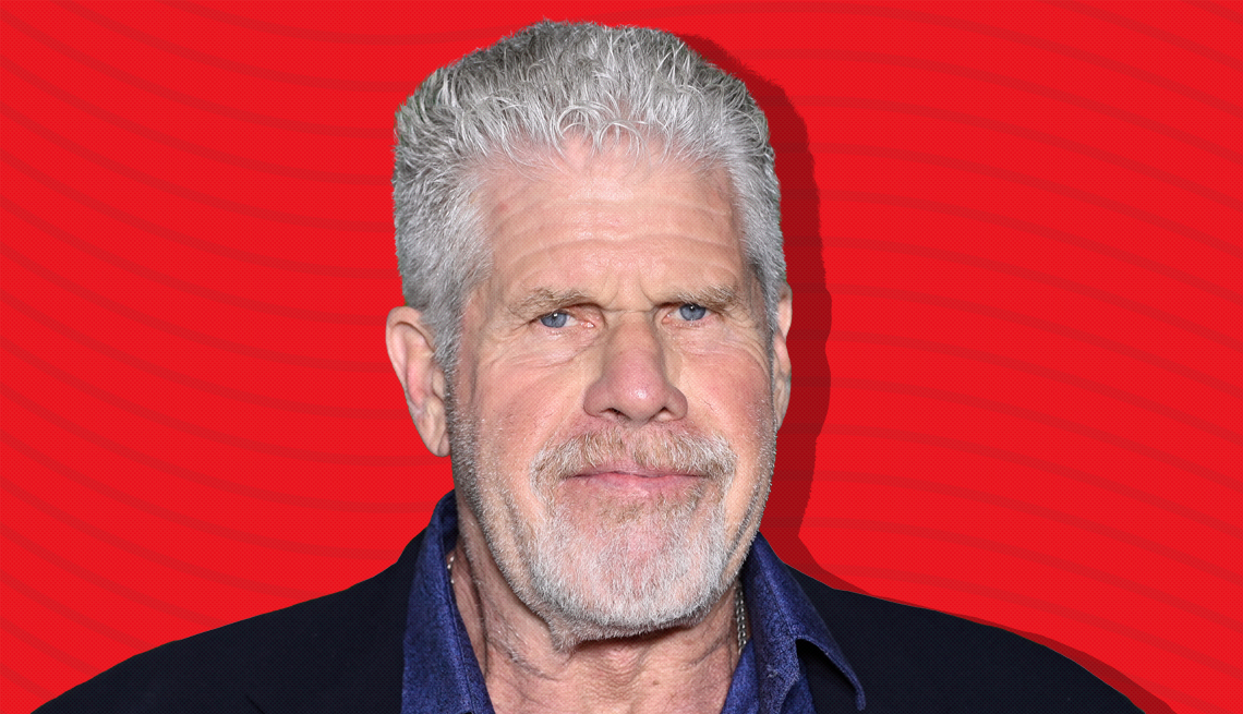 item 18 of Gallery image - ron perlman against red background with curved lines going horizontally from one end to the other