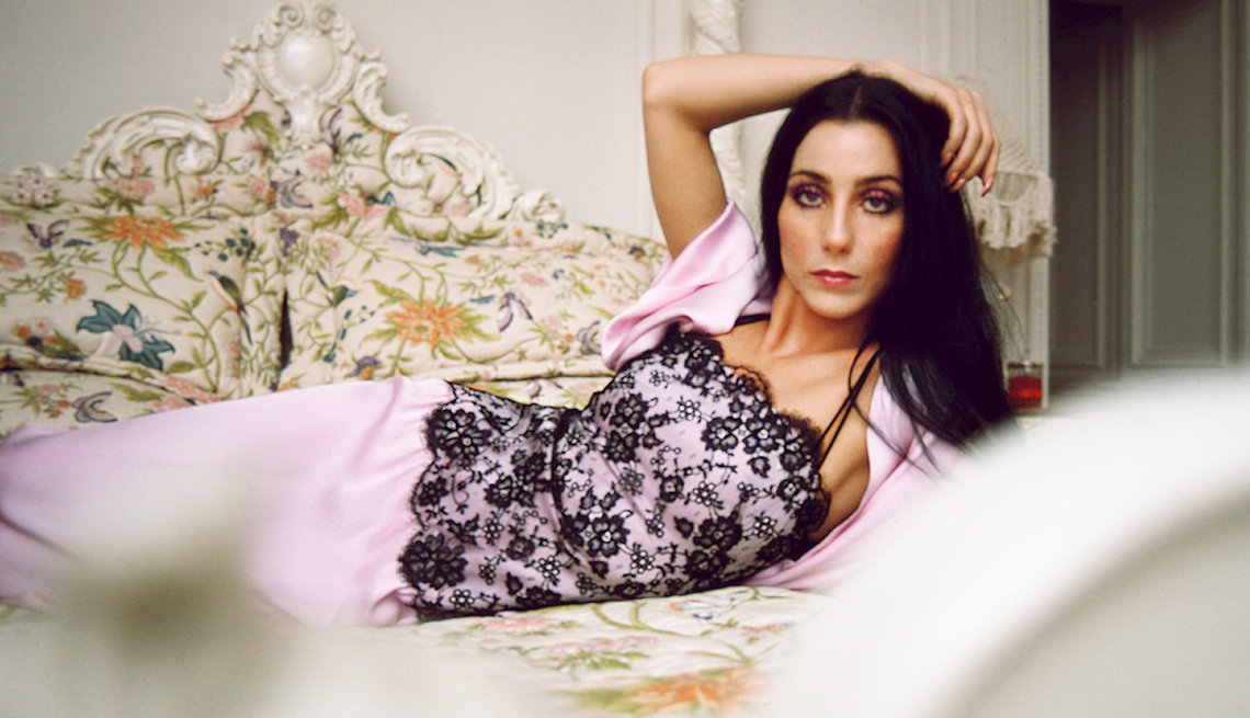 item 25 of Gallery image - Cher wearing lingerie lying on a bed in her home